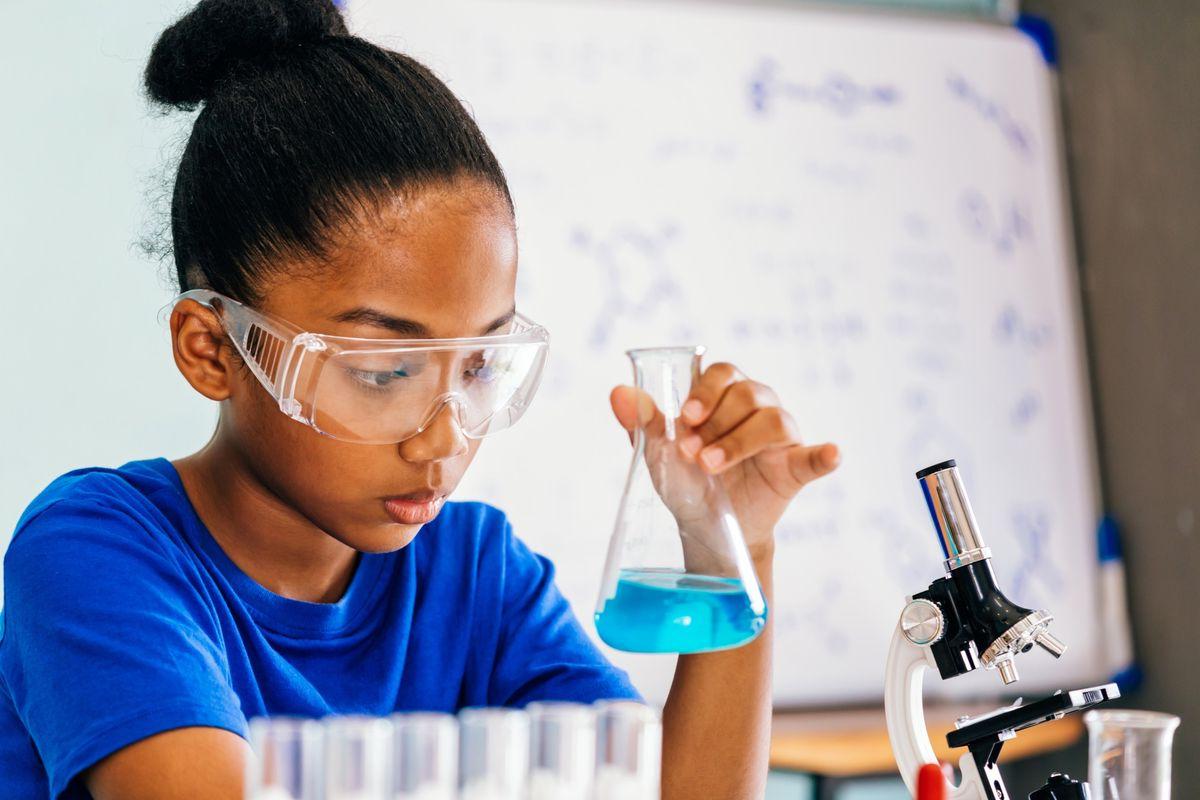 AstraZeneca woman scientist working in STEM-focused laboratory with pipette